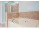 A cozy bathtub featuring tile backsplash and a glass door shower enclosure at 411 Mountain View Ln, Woodstock, GA 30188