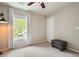 Bedroom with a window, ottoman, carpet, and neutral wall color at 411 Mountain View Ln, Woodstock, GA 30188