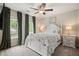 Bedroom with natural light, carpet, a ceiling fan, and a white four-poster bed at 411 Mountain View Ln, Woodstock, GA 30188