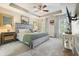 The main bedroom includes a ceiling fan, tray ceiling, carpeted floor and plenty of light at 411 Mountain View Ln, Woodstock, GA 30188