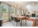 Open-concept dining area with large windows and living room views at 411 Mountain View Ln, Woodstock, GA 30188