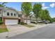 Street view of townhome complex with multiple attached garages and beautifully landscaped yards at 411 Mountain View Ln, Woodstock, GA 30188