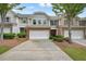 Charming townhome featuring a brick facade, attached garage, and well-maintained landscaping at 411 Mountain View Ln, Woodstock, GA 30188