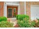 Close-up of a charming front entrance, adorned with colorful flowers and neat landscaping at 411 Mountain View Ln, Woodstock, GA 30188