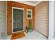 Cozy front porch featuring brickwork, a black door, and decorative plants at 411 Mountain View Ln, Woodstock, GA 30188