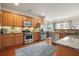 The kitchen features granite counters, stainless appliances, and wood cabinets and floors at 411 Mountain View Ln, Woodstock, GA 30188
