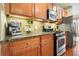 This kitchen features stainless appliances, granite countertops, and stylish decor at 411 Mountain View Ln, Woodstock, GA 30188