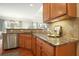 A partial kitchen view showcases granite counters, stainless appliances, and wood cabinets at 411 Mountain View Ln, Woodstock, GA 30188