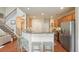 Open kitchen featuring a breakfast bar, stainless steel appliances, and staircase at 411 Mountain View Ln, Woodstock, GA 30188