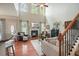 Spacious living room with a fireplace, tall windows, and modern decor at 411 Mountain View Ln, Woodstock, GA 30188