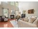 Bright living room featuring a fireplace, tall windows, and comfortable seating at 411 Mountain View Ln, Woodstock, GA 30188