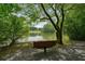 A serene pond with a bench under a tree, providing a peaceful outdoor space at 411 Mountain View Ln, Woodstock, GA 30188