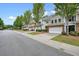 View of the townhome complex with tree-lined street, driveways, and well-manicured front yards at 411 Mountain View Ln, Woodstock, GA 30188