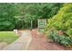 Entrance to a private trail with a stone sign and a well-maintained pathway at 411 Mountain View Ln, Woodstock, GA 30188