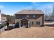Backyard view of a two-story house with a covered patio area at 5915 Partners Pass, Cumming, GA 30028