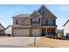 A beautiful two-story brick and siding home with a two-car garage at 5915 Partners Pass, Cumming, GA 30028