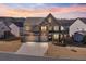 Stunning two-story home featuring a brick facade, well-manicured landscaping, and a spacious three-car garage at 5915 Partners Pass, Cumming, GA 30028