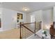 Hallway with staircase featuring black iron railing at 5915 Partners Pass, Cumming, GA 30028