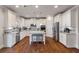 Bright kitchen with white cabinetry, stainless steel appliances, granite countertops, and a center island at 5915 Partners Pass, Cumming, GA 30028