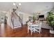 Open floor plan showcases hardwood floors, a staircase, and a combined living and dining area with ample natural light at 5915 Partners Pass, Cumming, GA 30028