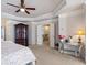 The main bedroom features tray ceilings, a cabinet, and a mirrored console table at 5915 Partners Pass, Cumming, GA 30028