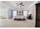 Spacious main bedroom boasts a tray ceiling, sitting area, and decorative wall at 5915 Partners Pass, Cumming, GA 30028