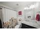 Bright bathroom featuring marble countertops and an ornate shower curtain at 7880 Brands Hatch Blvd, Cumming, GA 30040