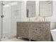 Bathroom featuring double vanity with vessel sinks and walk-in shower at 7880 Brands Hatch Blvd, Cumming, GA 30040