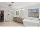 Modern bathroom with glass shower, soaking tub, double sink vanity, and a large window at 7880 Brands Hatch Blvd, Cumming, GA 30040