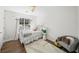 Bright bedroom with a window, light gray bedding, and a decorative chair at 7880 Brands Hatch Blvd, Cumming, GA 30040