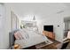 Bright primary bedroom features an abundance of natural light and a decorative chandelier at 7880 Brands Hatch Blvd, Cumming, GA 30040