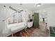 Bright bedroom featuring a window seat, green door, and view to the living space at 7880 Brands Hatch Blvd, Cumming, GA 30040