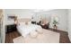 Bright bedroom features neutral colors, a ceiling fan, and a sitting area next to a window at 7880 Brands Hatch Blvd, Cumming, GA 30040