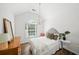 Well-lit bedroom with natural light, wood floors and a plush bed at 7880 Brands Hatch Blvd, Cumming, GA 30040