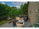 Outdoor deck with multiple seating options and a view of the trees at 7880 Brands Hatch Blvd, Cumming, GA 30040