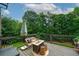 Outdoor deck with seating and a view of the private backyard at 7880 Brands Hatch Blvd, Cumming, GA 30040