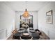 Elegant dining room with wainscoting, hardwood floors, and chandelier lighting at 7880 Brands Hatch Blvd, Cumming, GA 30040