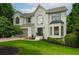 Beautiful two-story home with a white brick exterior, well-manicured lawn, and attached two-car garage at 7880 Brands Hatch Blvd, Cumming, GA 30040