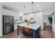 Bright kitchen with an island, bar stool seating, and updated appliances at 7880 Brands Hatch Blvd, Cumming, GA 30040