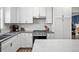 Well-equipped kitchen featuring white cabinets, a gas range, and modern countertops at 7880 Brands Hatch Blvd, Cumming, GA 30040