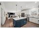 Open-concept kitchen featuring a large island, white cabinetry, and stainless steel appliances at 7880 Brands Hatch Blvd, Cumming, GA 30040