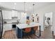 Stylish kitchen with marble countertops, a center island, and stainless steel appliances at 7880 Brands Hatch Blvd, Cumming, GA 30040