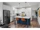Charming kitchen featuring a breakfast bar, stainless steel appliances, and ample lighting at 7880 Brands Hatch Blvd, Cumming, GA 30040
