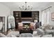 Comfortable living room with a fireplace, a built-in shelving unit and stylish decor at 7880 Brands Hatch Blvd, Cumming, GA 30040