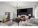 Cozy living room with a fireplace, a stylish decor, and a built-in shelving at 7880 Brands Hatch Blvd, Cumming, GA 30040