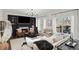 Inviting living room with a fireplace, built-in shelving, and large windows overlooking the outdoor view at 7880 Brands Hatch Blvd, Cumming, GA 30040