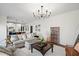 Open-concept living room and kitchen featuring modern decor and ample natural light at 7880 Brands Hatch Blvd, Cumming, GA 30040