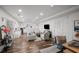 Open concept living space with stylish seating, wood floors, and modern décor at 7880 Brands Hatch Blvd, Cumming, GA 30040