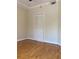 Bright bedroom with hardwood floors, white trim and door and an air conditioning vent at 1075 Peachtree Walk # A205, Atlanta, GA 30309