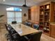 Well-appointed conference room with a large granite table, executive chairs, and custom built-in cabinetry at 1075 Peachtree Walk # A205, Atlanta, GA 30309